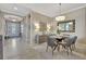 Elegant dining room with a glass-top table and gray chairs at 4020 Cascina Way, Sarasota, FL 34238