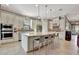 Modern kitchen with white cabinets, large island, and tile flooring at 4020 Cascina Way, Sarasota, FL 34238