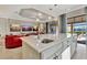 Island kitchen with white cabinets, quartz countertops, and stainless steel sink at 4020 Cascina Way, Sarasota, FL 34238