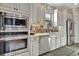 Modern kitchen features stainless steel appliances and white shaker cabinets at 4020 Cascina Way, Sarasota, FL 34238