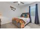 Bedroom with gray bed frame and colorful quilt at 4110 Mossy Limb Ct, Palmetto, FL 34221