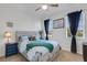 Bright bedroom with a queen bed and teal accents at 4110 Mossy Limb Ct, Palmetto, FL 34221