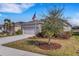 Landscaped yard with mature trees and a welcoming front porch at 4110 Mossy Limb Ct, Palmetto, FL 34221