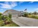 Attractive curb appeal with a neutral color palette and lush landscaping at 4110 Mossy Limb Ct, Palmetto, FL 34221