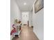 Long hallway with tile floor and decorative console table at 4110 Mossy Limb Ct, Palmetto, FL 34221