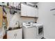 Bright laundry room with washer, dryer, and ample storage at 4110 Mossy Limb Ct, Palmetto, FL 34221