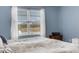 Main bedroom with large window and comfortable bed at 4110 Mossy Limb Ct, Palmetto, FL 34221