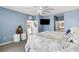 Main bedroom with a comfortable bed and access to the bathroom at 4110 Mossy Limb Ct, Palmetto, FL 34221