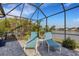 Relaxing screened patio with lounge chairs and lake view at 4110 Mossy Limb Ct, Palmetto, FL 34221