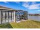 Relaxing screened patio overlooking a lake, complete with seating and lush landscaping at 4110 Mossy Limb Ct, Palmetto, FL 34221