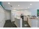 Well-equipped kitchen featuring white cabinets, stainless steel appliances, and an island at 4452 Mcintosh Lake Ave, Sarasota, FL 34233