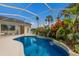 Inviting kidney-shaped pool with a waterfall feature at 4452 Mcintosh Lake Ave, Sarasota, FL 34233