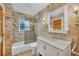 Updated bathroom with marble vanity, glass shower, and tile flooring at 5006 W Country Club Dr, Sarasota, FL 34243