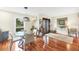 Bright dining area with hardwood floors and a glass dining table at 5006 W Country Club Dr, Sarasota, FL 34243