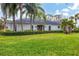 Single story home with spacious lawn and palm trees at 5006 W Country Club Dr, Sarasota, FL 34243