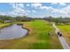 Golf course with players and golf cart at 5006 W Country Club Dr, Sarasota, FL 34243