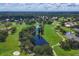 Aerial view of a golf course with a pond and surrounding landscape at 5006 W Country Club Dr, Sarasota, FL 34243