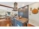 Sleek kitchen island with granite countertops and modern range hood at 5006 W Country Club Dr, Sarasota, FL 34243