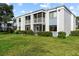 Building exterior with screened balconies and lush landscaping at 5310 26Th W St # 501, Bradenton, FL 34207