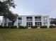 Condo building with screened balconies and grassy yard at 5310 26Th W St # 501, Bradenton, FL 34207