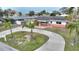 House with circular driveway and landscaped yard at 542 Baywood S Dr, Dunedin, FL 34698