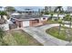 House with circular driveway and landscaped yard at 542 Baywood S Dr, Dunedin, FL 34698