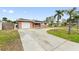 Front view of a single-story house with a two-car garage at 542 Baywood S Dr, Dunedin, FL 34698