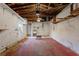 Unfinished garage with painted floor and storage at 542 Baywood S Dr, Dunedin, FL 34698