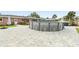 Above ground pool with surrounding patio and backyard view at 542 Baywood S Dr, Dunedin, FL 34698