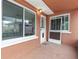 Covered patio with screen enclosure, offering backyard views at 542 Baywood S Dr, Dunedin, FL 34698