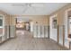 Under renovation: Sunroom with new flooring and exposed walls at 542 Baywood S Dr, Dunedin, FL 34698