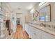 Bathroom with granite countertops, double vanity, and glass block shower at 5420 4Th Avenue Nw Dr, Bradenton, FL 34209