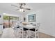 Bright dining area with whitewashed table and chairs near kitchen and pool view at 5420 4Th Avenue Nw Dr, Bradenton, FL 34209