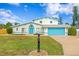 Stunning two-story home with a bright blue garage and nicely landscaped lawn at 5420 4Th Avenue Nw Dr, Bradenton, FL 34209