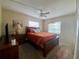 Bedroom with a queen bed, dresser and window at 5885 17Th W St # B21, Bradenton, FL 34207