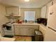 Efficient kitchen with white cabinets and appliances at 5885 17Th W St # B21, Bradenton, FL 34207