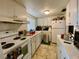 Efficient kitchen with white cabinets and appliances at 5885 17Th W St # B21, Bradenton, FL 34207