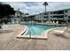 Community pool with lounge chairs at 5885 17Th W St # B21, Bradenton, FL 34207