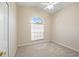 Well-lit bedroom featuring a large arched window and plush carpeting at 6234 Sturbridge Ct, Sarasota, FL 34238