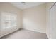 Cozy bedroom with neutral walls, carpet flooring, and window shutters at 6234 Sturbridge Ct, Sarasota, FL 34238