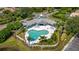 Community pool with a clubhouse and surrounding landscaping at 6234 Sturbridge Ct, Sarasota, FL 34238