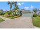 Single-Gathering home with a landscaped yard, driveway, and two-car garage at 6234 Sturbridge Ct, Sarasota, FL 34238