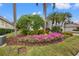 Landscaped front yard with colorful flowers and lush greenery at 6234 Sturbridge Ct, Sarasota, FL 34238