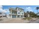 Two-story home with modern design, gray garage doors, and landscaped yard at 625 Jackson Way, Longboat Key, FL 34228