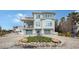 Two-story home with gray double garage doors and landscaped front yard at 625 Jackson Way, Longboat Key, FL 34228