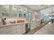 White kitchen with glass-front cabinets and expansive countertops at 625 Jackson Way, Longboat Key, FL 34228