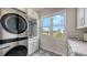 Laundry room with modern appliances and patterned tile floor at 625 Jackson Way, Longboat Key, FL 34228