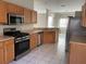 Kitchen with stainless steel appliances and wood cabinets at 6329 Robin Cv, Lakewood Ranch, FL 34202