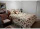 Cozy bedroom with floral bedding and wicker chair at 6440 Mourning Dove Dr # 101, Bradenton, FL 34210