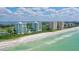 Aerial view of beachfront condos with ocean and city views at 675 Longboat Club Rd # 22A, Longboat Key, FL 34228